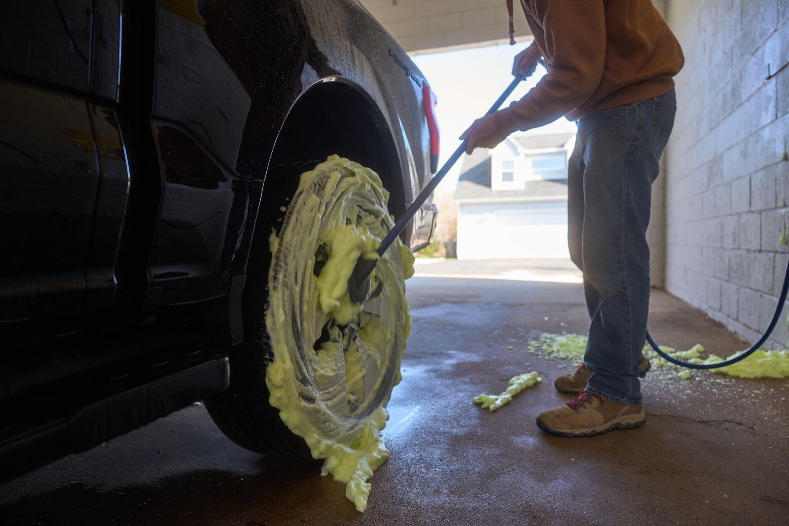 Cleaning The Tire With Soap And Water At The Washbox